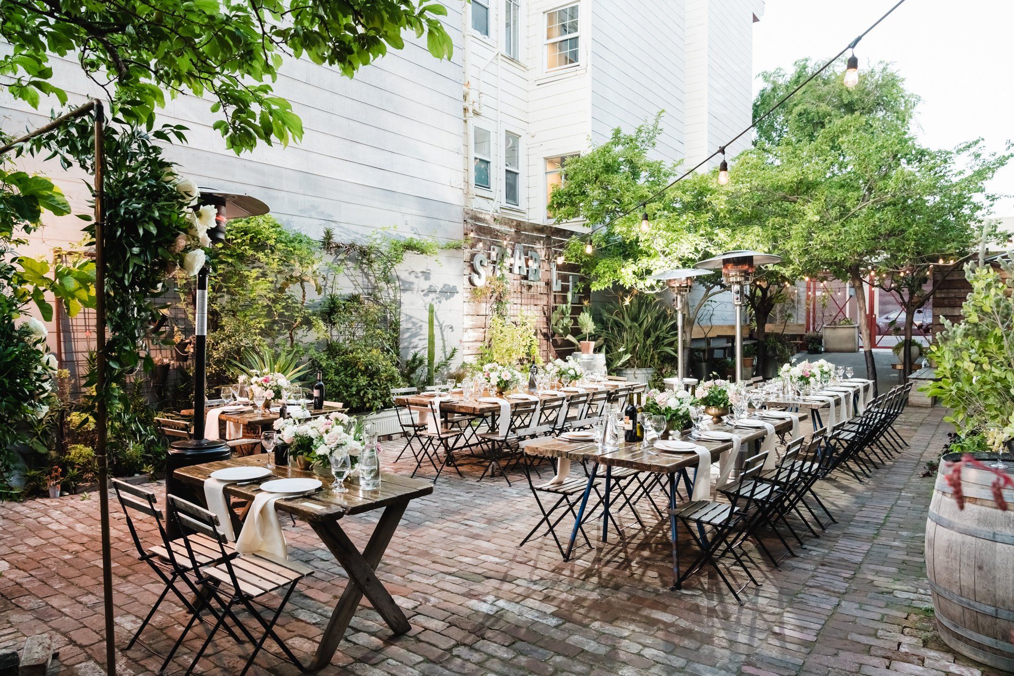 industrial-cafe micro wedding at stable cafe, sf, Dinner on the String-Lit Patio at Stable Cafe